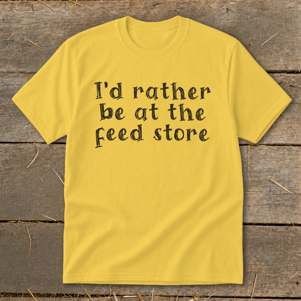 Yellow t-shirt with black text that reads "I'd rather be at the feed store".