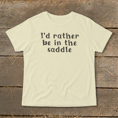 Cream t-shirt with black text that reads "I'd rather be in the saddle."