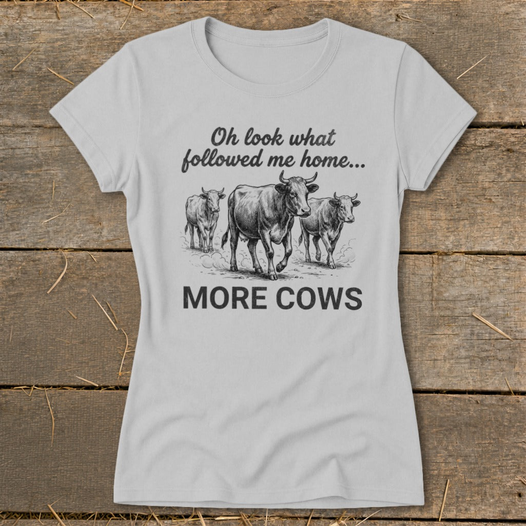 Light grey t-shirt with "Oh look what followed me home... MORE COWS" and cow illustration.