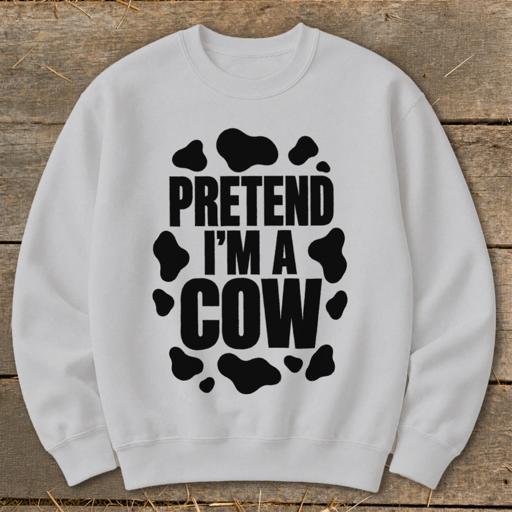 White crewneck sweatshirt with "Pretend I'm a Cow" text and black cow spots.