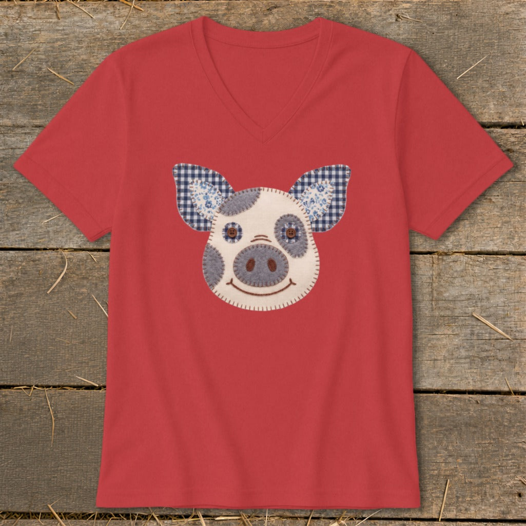 Red v-neck t-shirt with a felt pig face applique featuring gingham ears.
