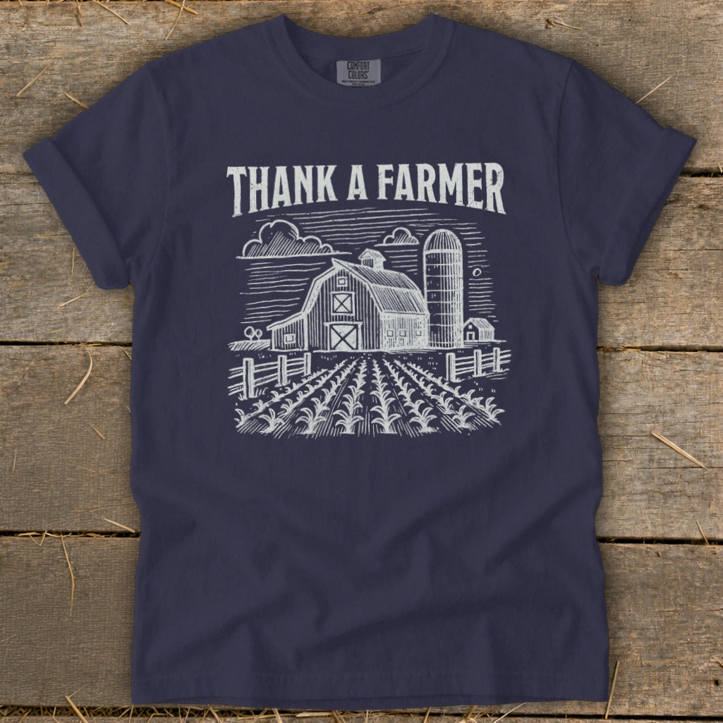 Navy t-shirt with "THANK A FARMER" and a sketch of a farm scene.