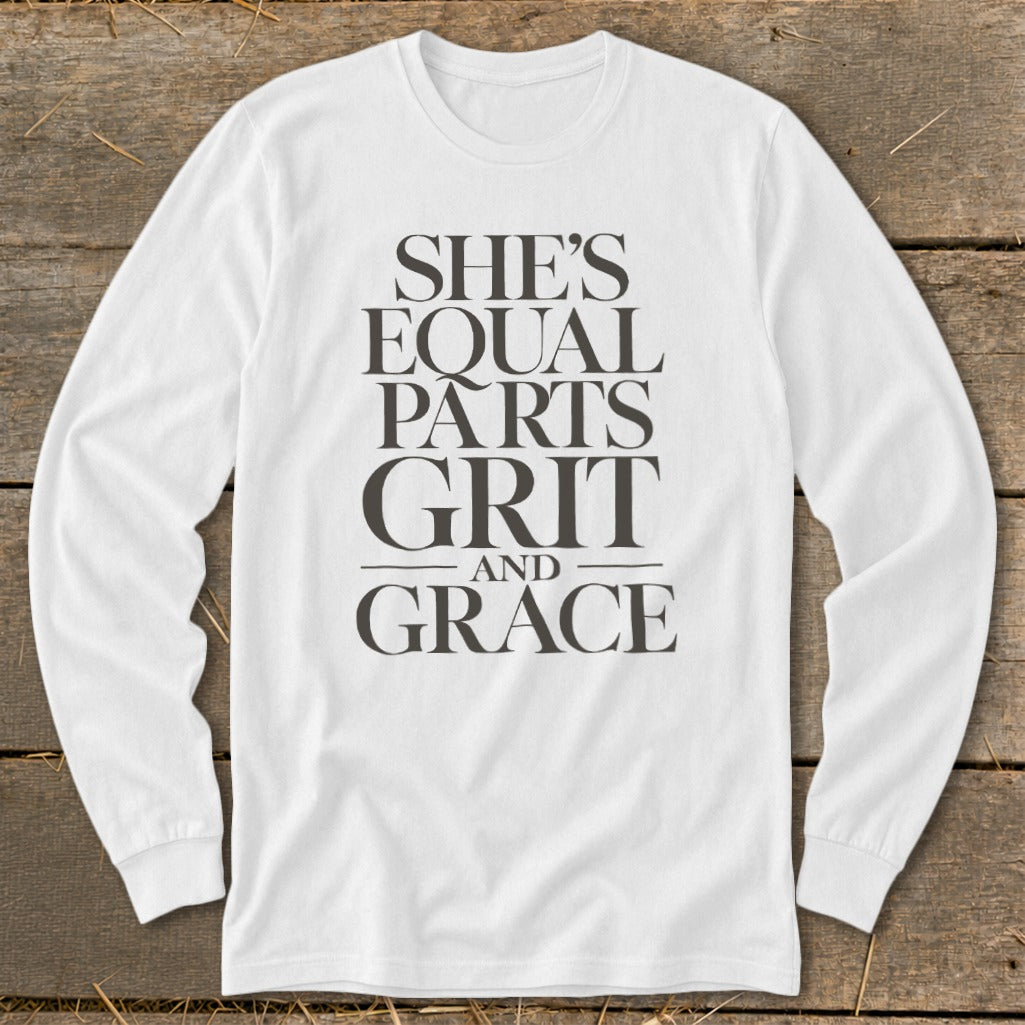 White long-sleeve shirt with text: She's Equal Parts Grit and Grace.