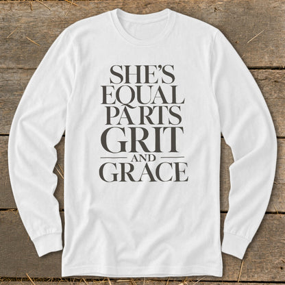 White long-sleeve shirt with text: She's Equal Parts Grit and Grace.