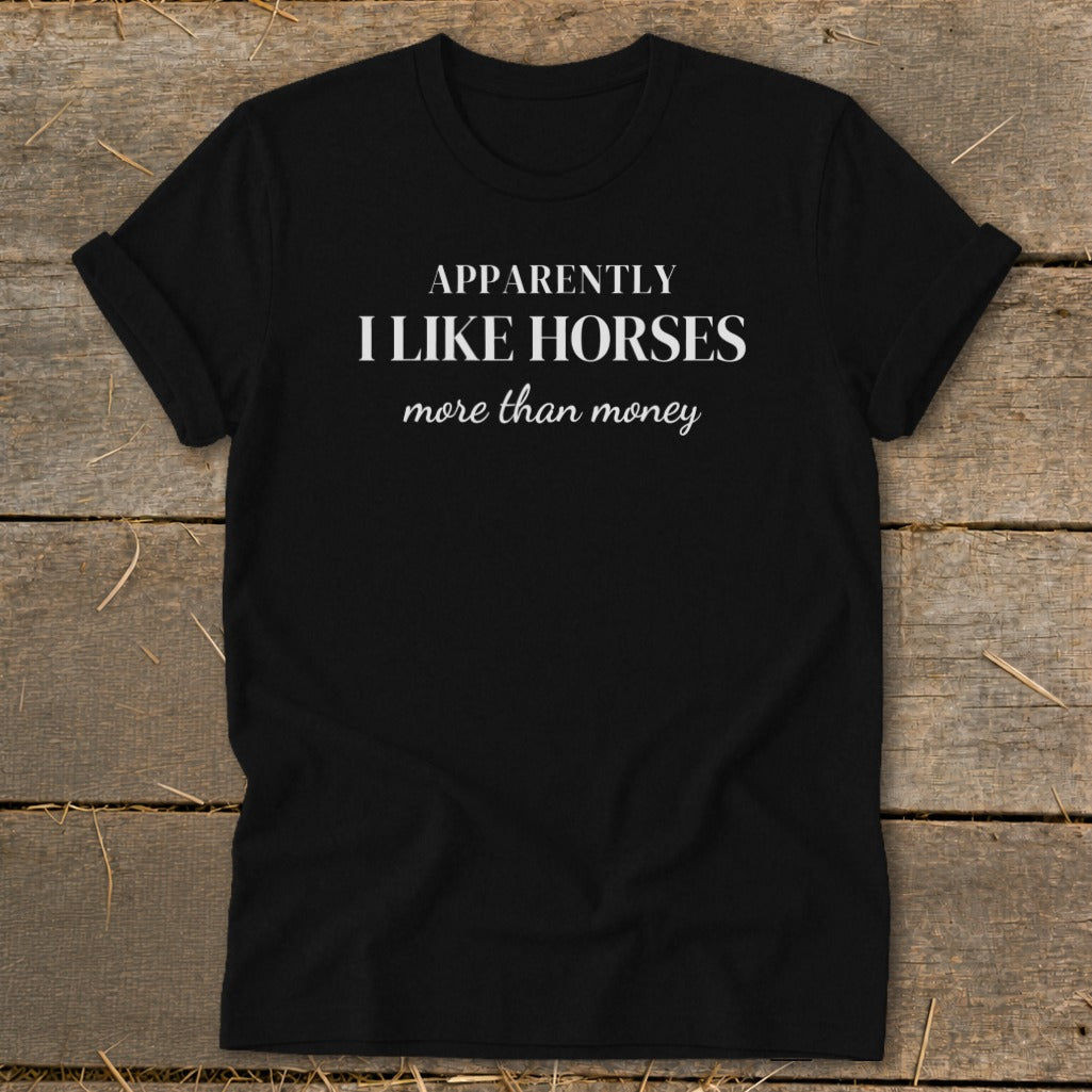 Black t-shirt with white text "Apparently I like horses more than money."