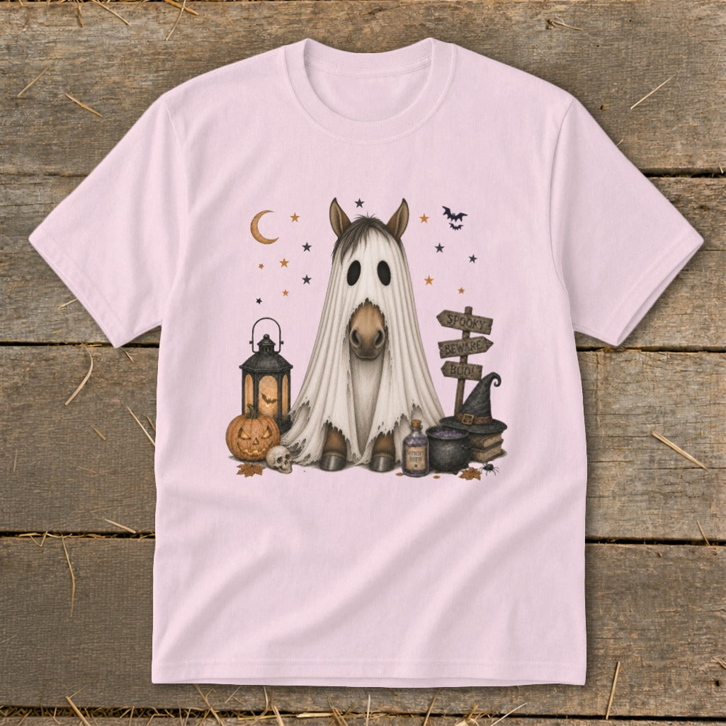 A horse dressed as a ghost sits with Halloween decorations.