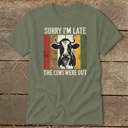 Green t-shirt with a cow graphic and text that reads "Sorry I'm Late, The Cows Were Out."