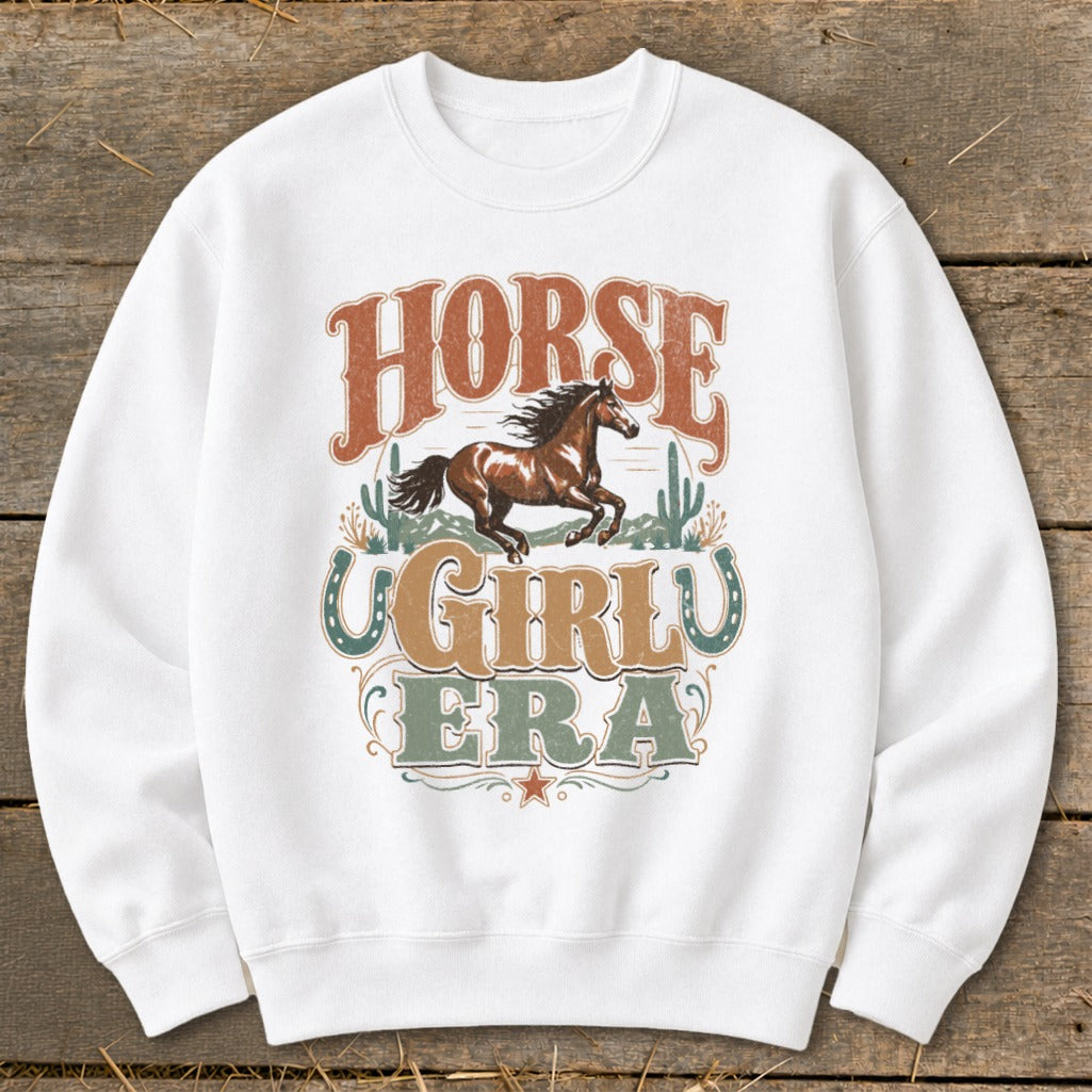White sweatshirt with "Horse Girly Era" text and a running horse graphic.