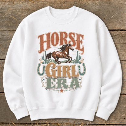 White sweatshirt with "Horse Girly Era" text and a running horse graphic.