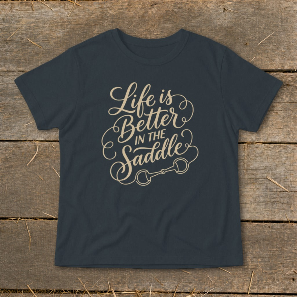 Dark grey t-shirt with beige text "Life is Better in the Saddle" and horse bit graphic.