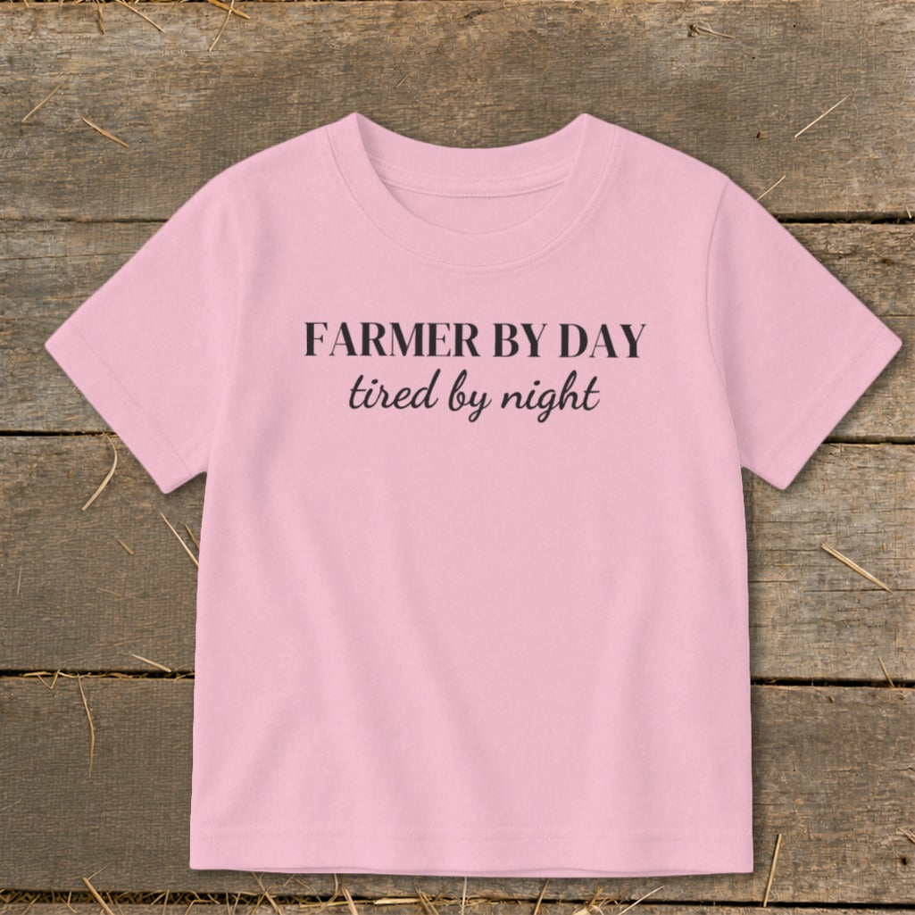 Pink t-shirt with "FARMER BY DAY tired by night" text.