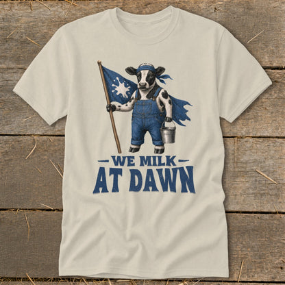 Cow in overalls and cape holding flag with milk splash, text reads "We Milk At Dawn."