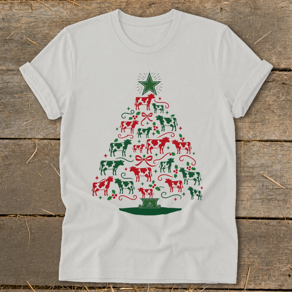 White t-shirt with a Christmas tree made of red and green cows and holly.