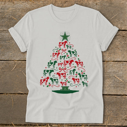 White t-shirt with a Christmas tree made of red and green cows and holly.