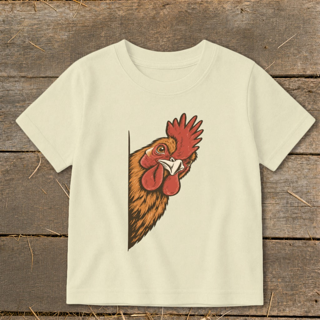 Cream t-shirt with a cartoon illustration of a rooster peeking from the left.