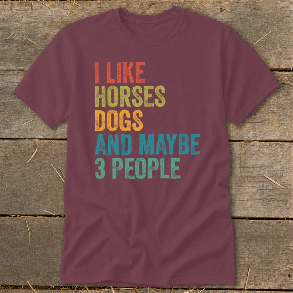 Maroon t-shirt with text "I LIKE HORSES DOGS AND MAYBE 3 PEOPLE".