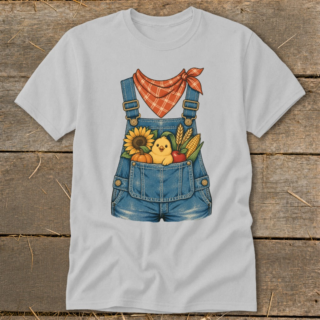 Gray t-shirt with a graphic of denim overalls filled with autumn harvest items and a chick.