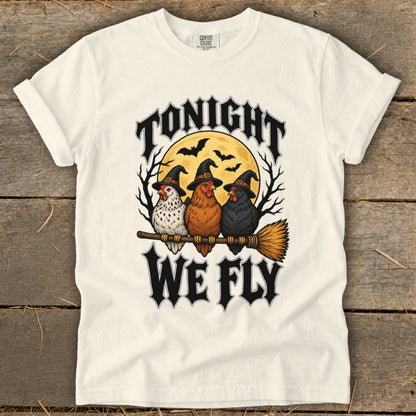 Three chickens wearing witch hats sit on a broomstick with text "Tonight We Fly".