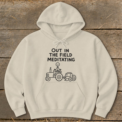 Cream hoodie with black text and illustration of stick figure meditating on a tractor.