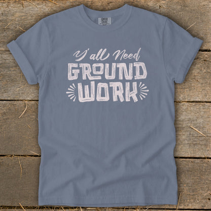 Blue t-shirt with white text "Y'all Need GROUND WORK" centered.