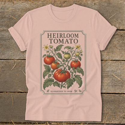 Pink t-shirt with "Heirloom Tomato" design featuring a vine with ripe and unripe tomatoes and yellow flowers.