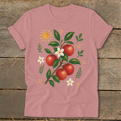 T-shirt with a painted branch of red apples, white blossoms, and a sun.