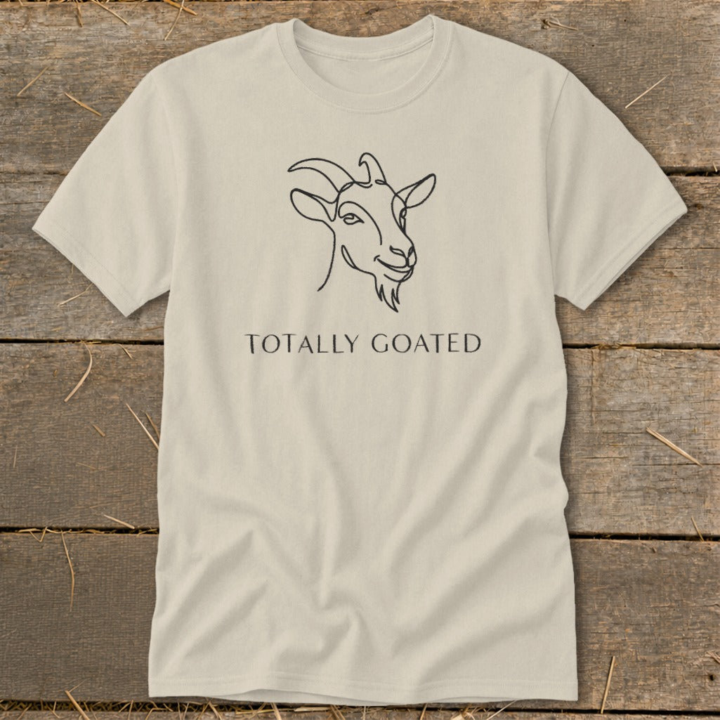 Light tan t-shirt with black line drawing of a goat's head and text "TOTALLY GOATED".
