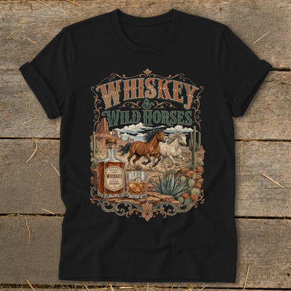 Black t-shirt with "Whiskey & Wild Horses" graphic featuring running horses, whiskey bottle, and desert landscape.