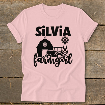 Pink t-shirt with "Silvia farmgirl" text, barn, tractor, and windmill graphics.