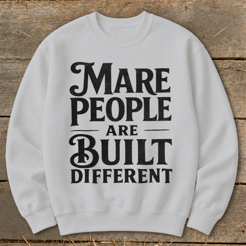 White sweatshirt with "Mare People Are Built Different" text in black.