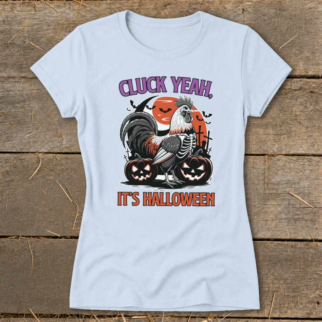 Light blue t-shirt with skeleton rooster, pumpkins, and text "CLUCK YEAH, IT'S HALLOWEEN".