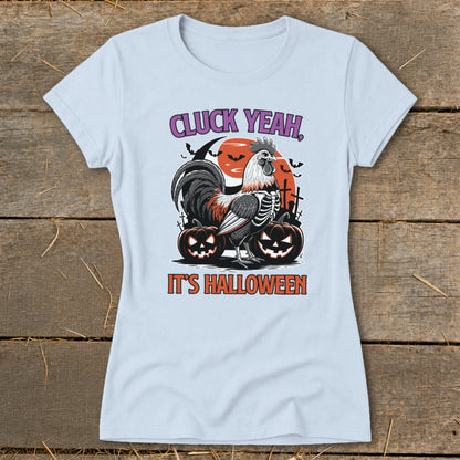 Light blue t-shirt with skeleton rooster, pumpkins, and text "CLUCK YEAH, IT'S HALLOWEEN".