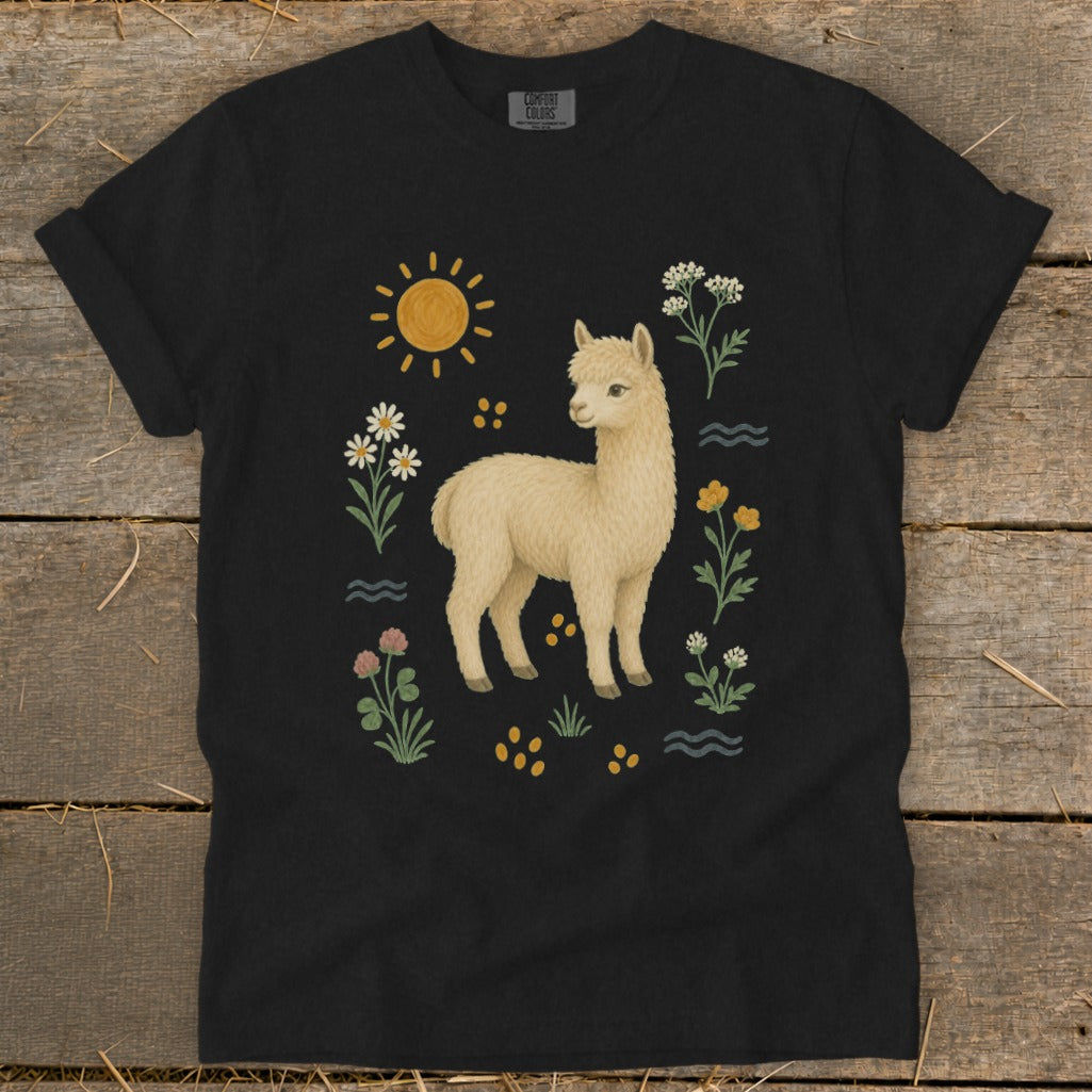 Black t-shirt with a cream alpaca and a sunny, floral design.