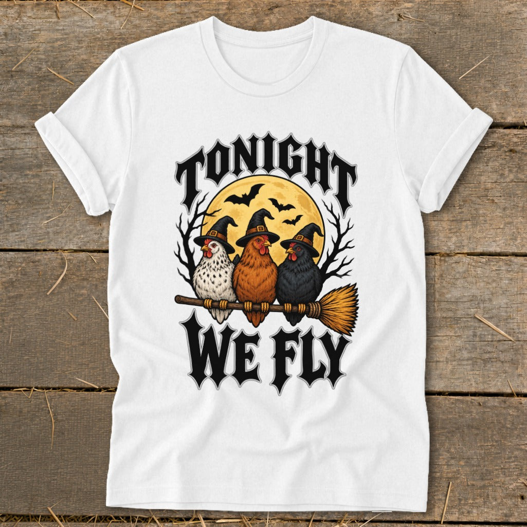 Three chickens in witch hats sit on a broomstick under a full moon, reading "Tonight We Fly".