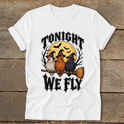 Three chickens in witch hats sit on a broomstick under a full moon, reading "Tonight We Fly".