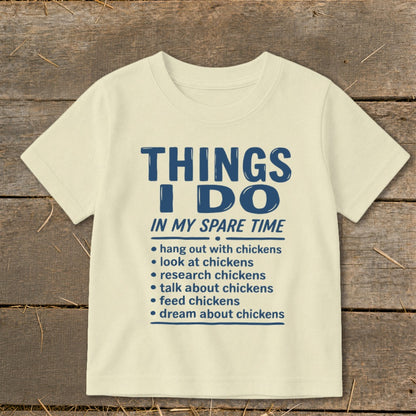 Light yellow t-shirt with blue text listing "Things I Do In My Spare Time".