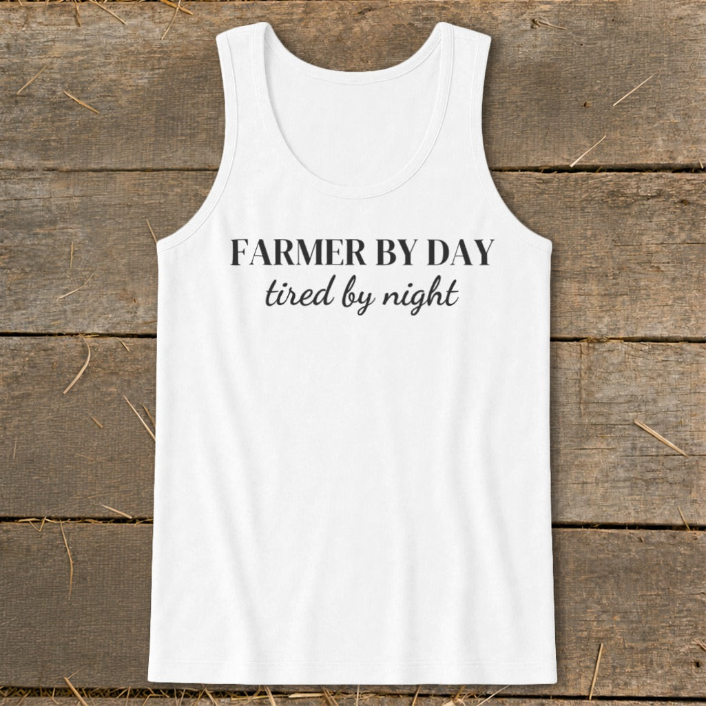 White tank top with black text reading "FARMER BY DAY tired by night".