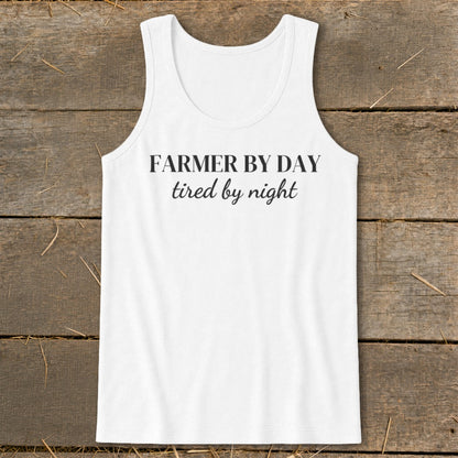 White tank top with black text reading "FARMER BY DAY tired by night".