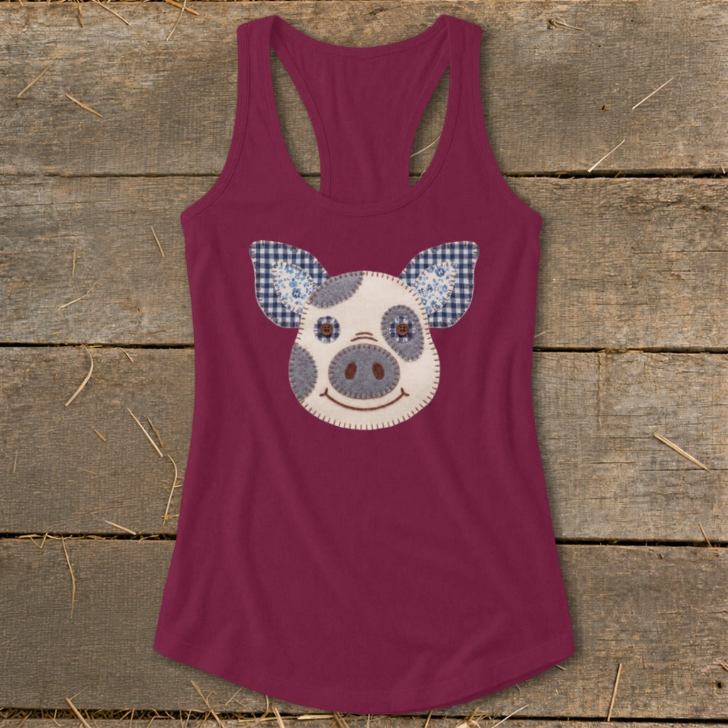 Burgundy racerback tank top with a white pig face applique.
