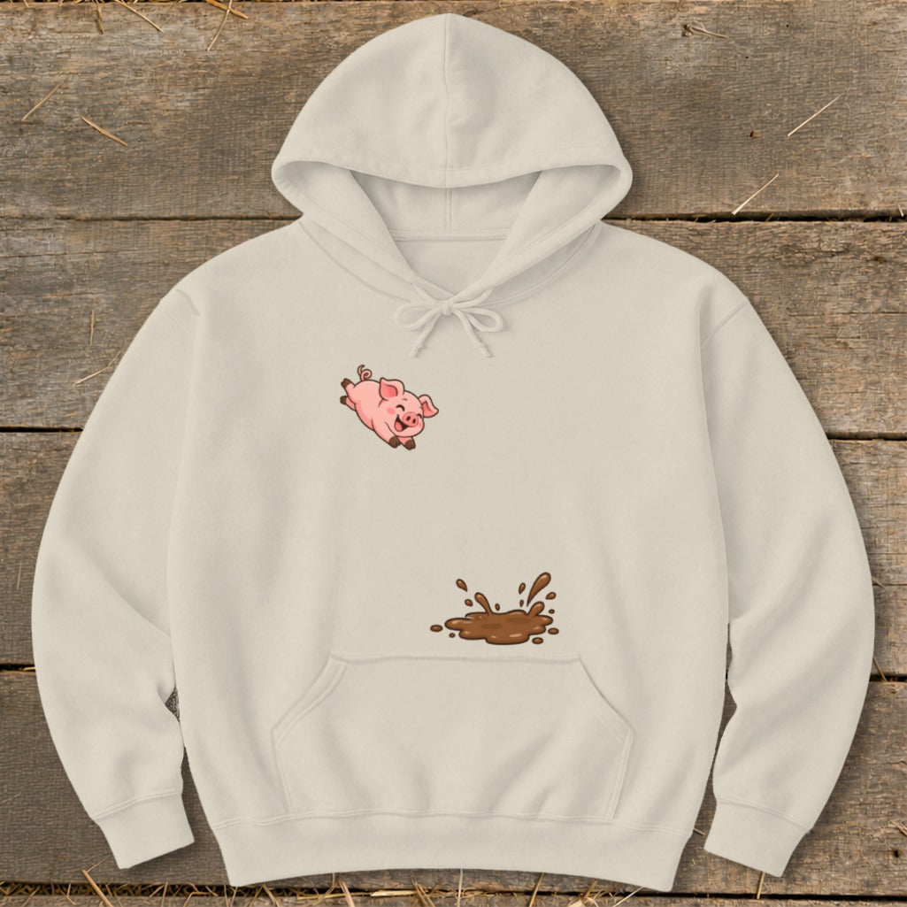 Cream hoodie with a cartoon pig jumping over a mud puddle graphic.