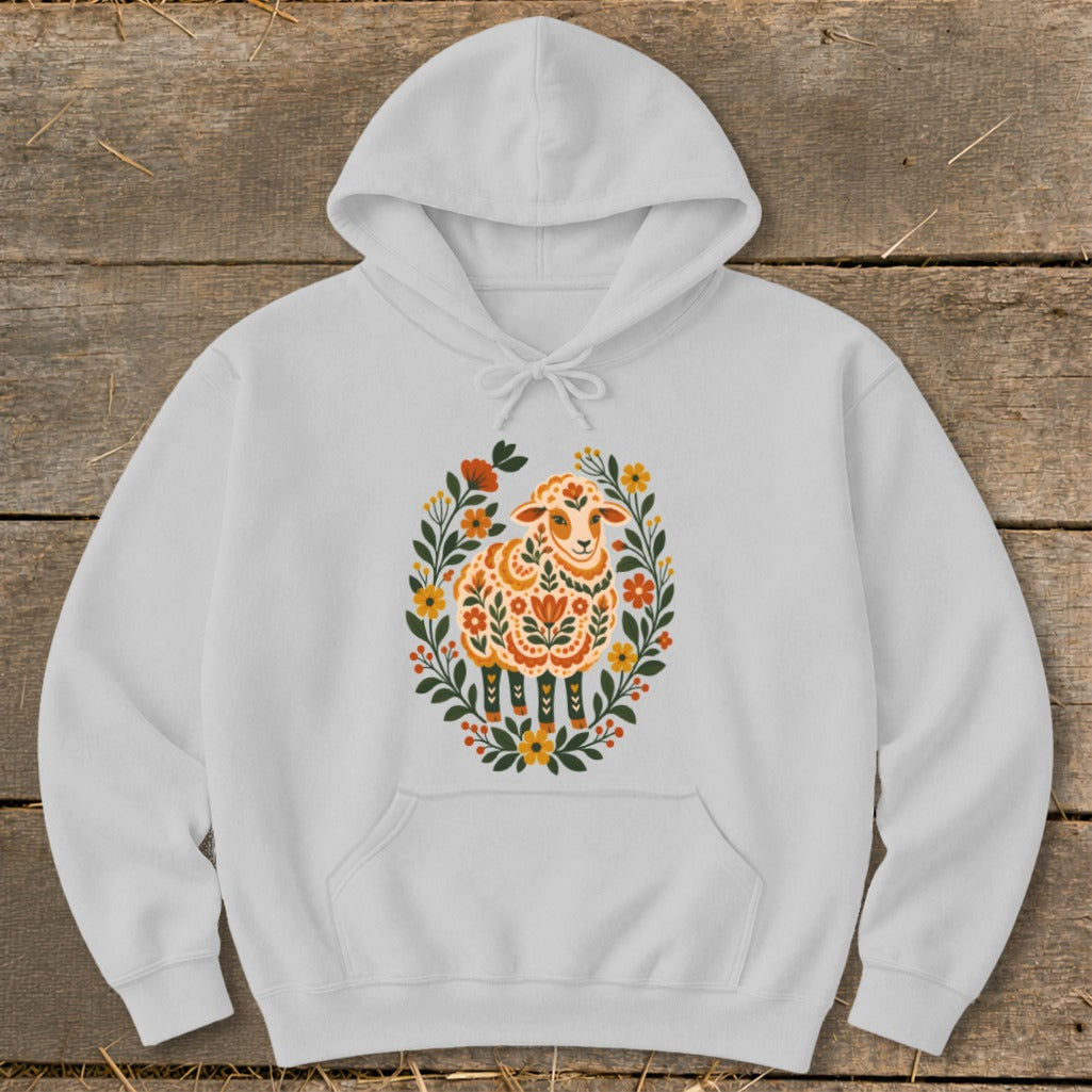 White hoodie with folk art sheep and floral wreath design.