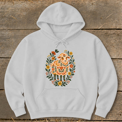 White hoodie with folk art sheep and floral wreath design.