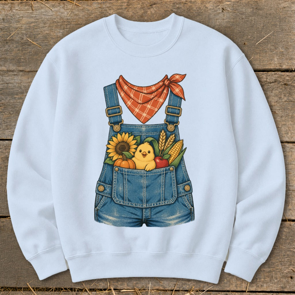 White sweatshirt with denim overalls graphic featuring a chick, sunflower, pumpkin, apple, and corn.