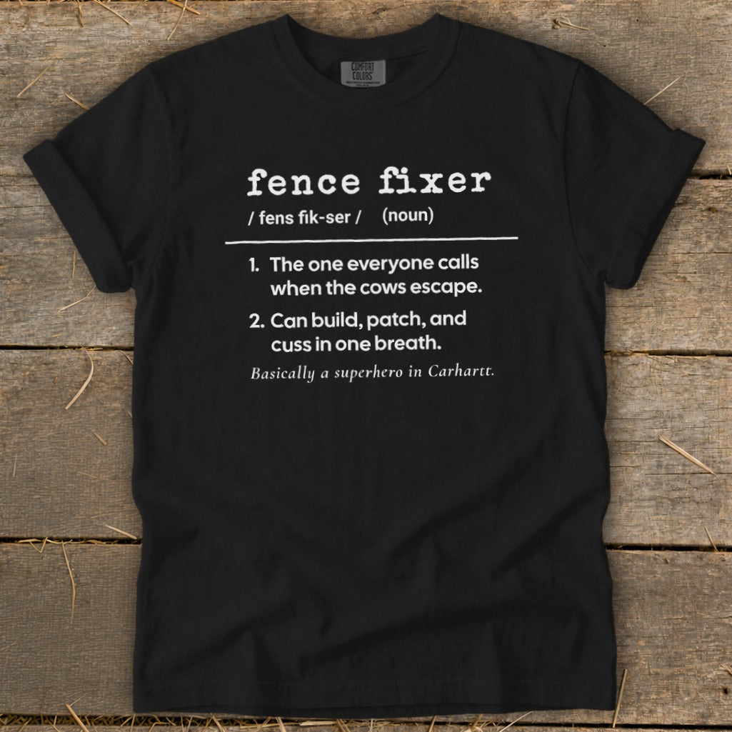 Black t-shirt with "Fence Fixer" definition: calls when cows escape, builds, patches, cusses.