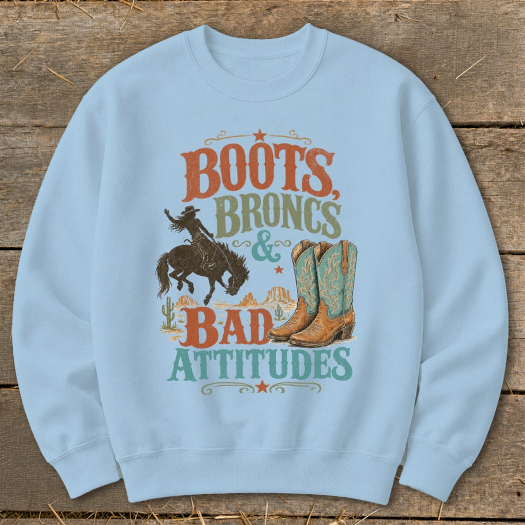 Light blue sweatshirt with "Boots, Broncs & Bad Attitudes" graphic.