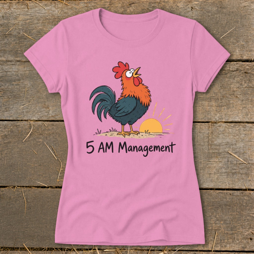 Pink t-shirt with a cartoon rooster and sunrise graphic that reads "5 AM Management".