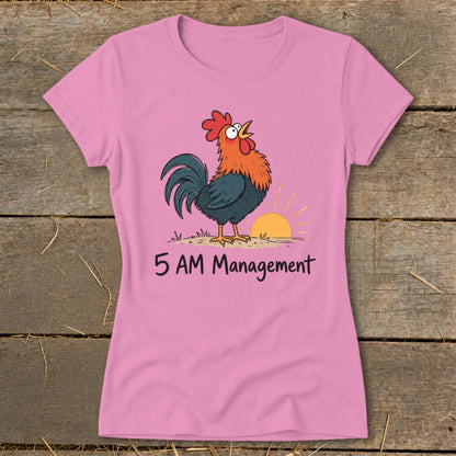 Pink t-shirt with a cartoon rooster and sunrise graphic that reads "5 AM Management".