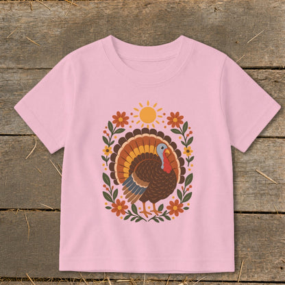 Pink t-shirt with a Thanksgiving turkey and floral design.