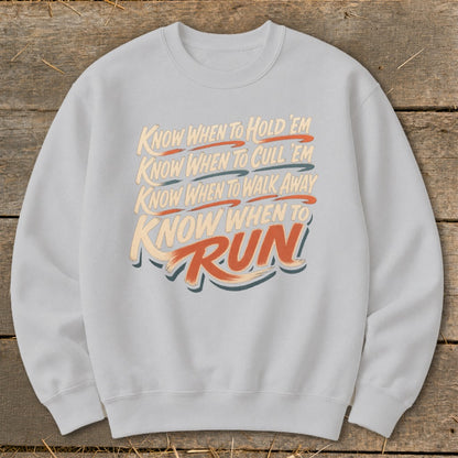 Light gray sweatshirt with text: "Know when to hold 'em, know when to cull 'em, know when to walk away, know when to run."