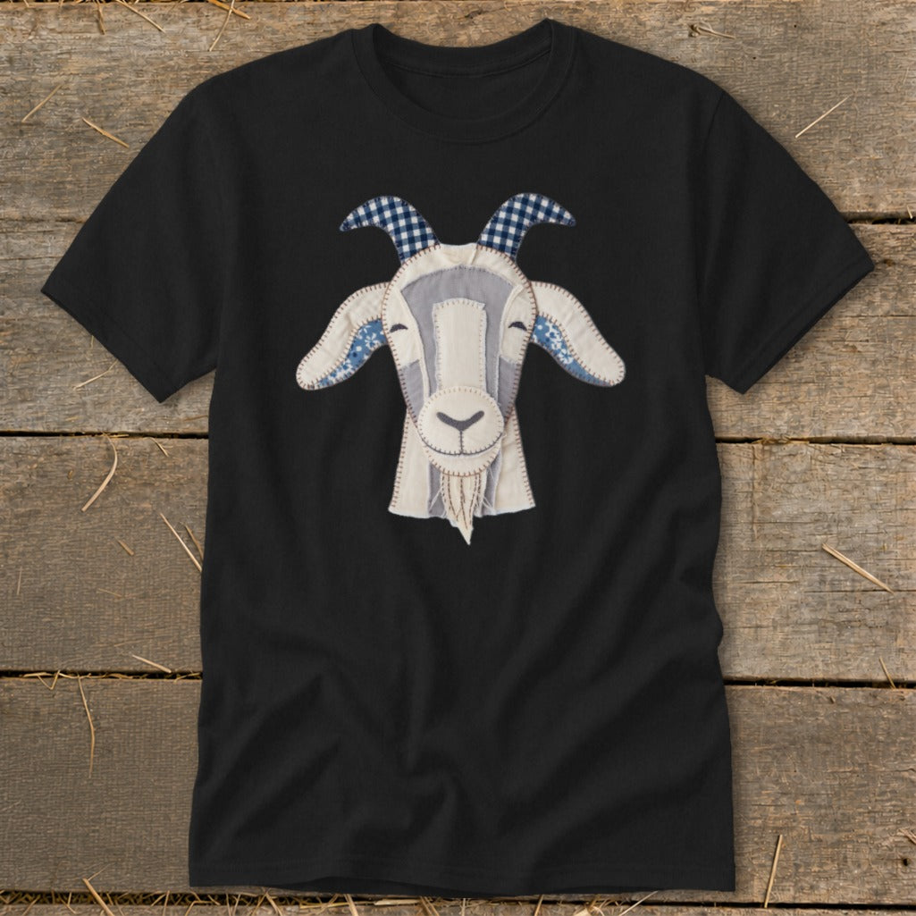 Black t-shirt with a fabric applique of a smiling goat's head.